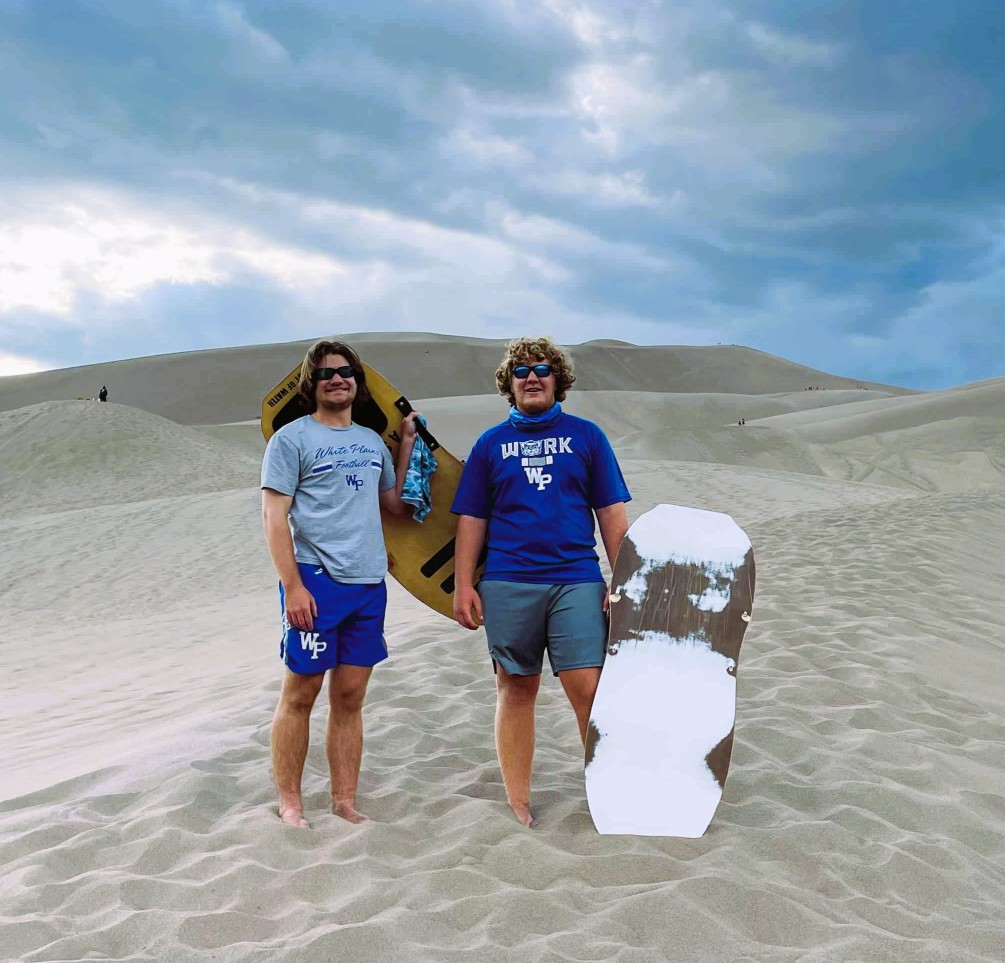 Colorado Road Trip to Great Sand Dunes National Park waiting to sled down the moutain